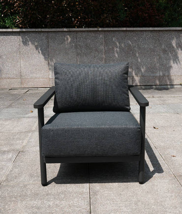 Grey aluminium chair designed for outdoor use on a concrete surface