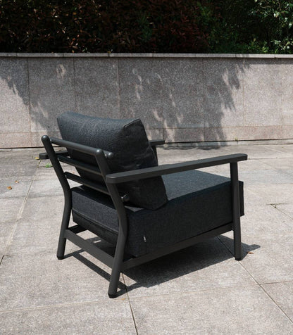 Two-seat aluminium sofa with black cushions on a patio setting