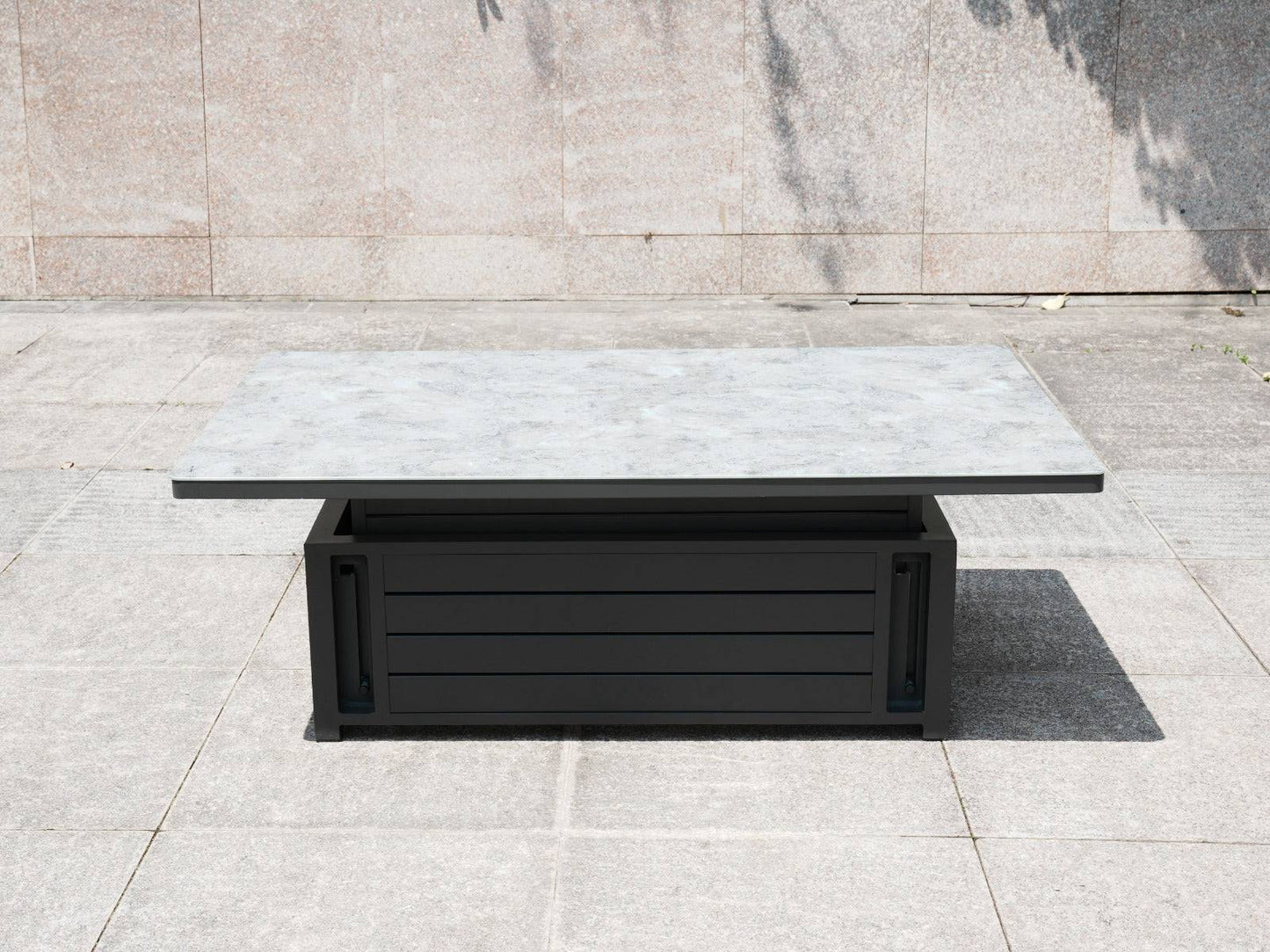 Square rising table with a patterned top and black aluminum base