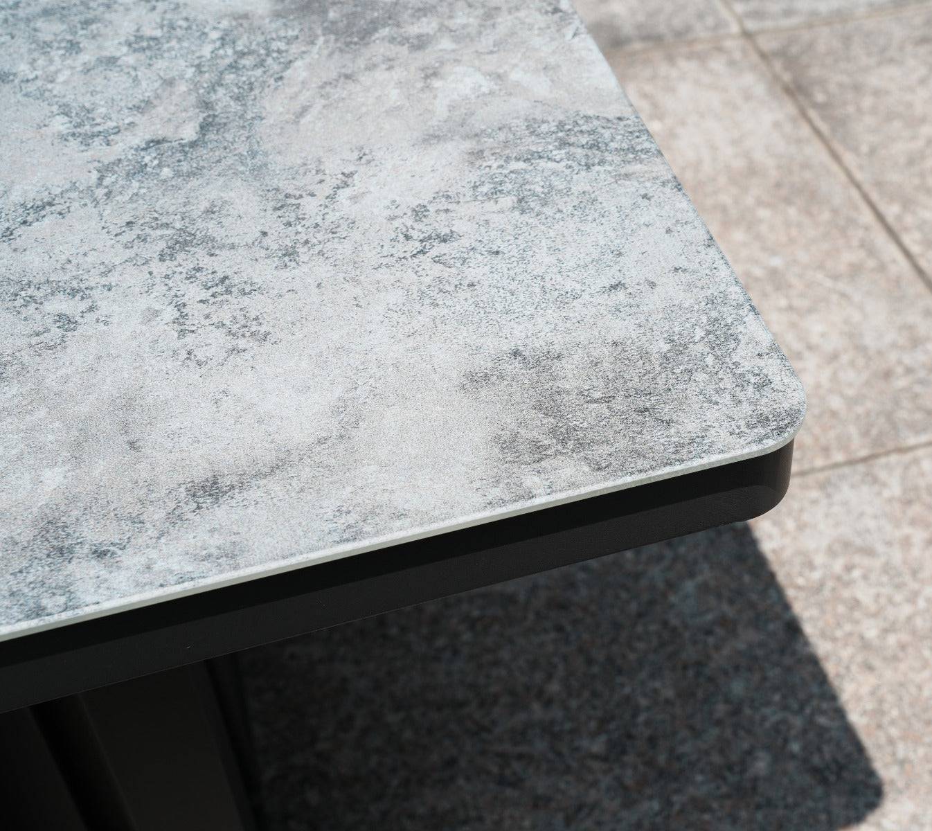 Detailed view of the patterned rising table's grey surface